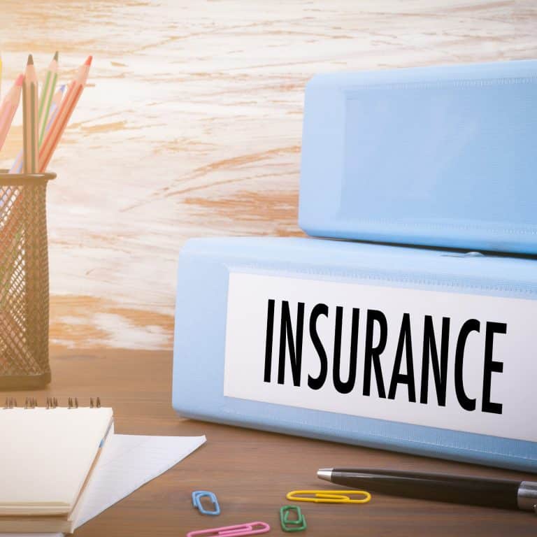 Image of a binder with the word insurance which has information on why do most personal injury claims settle